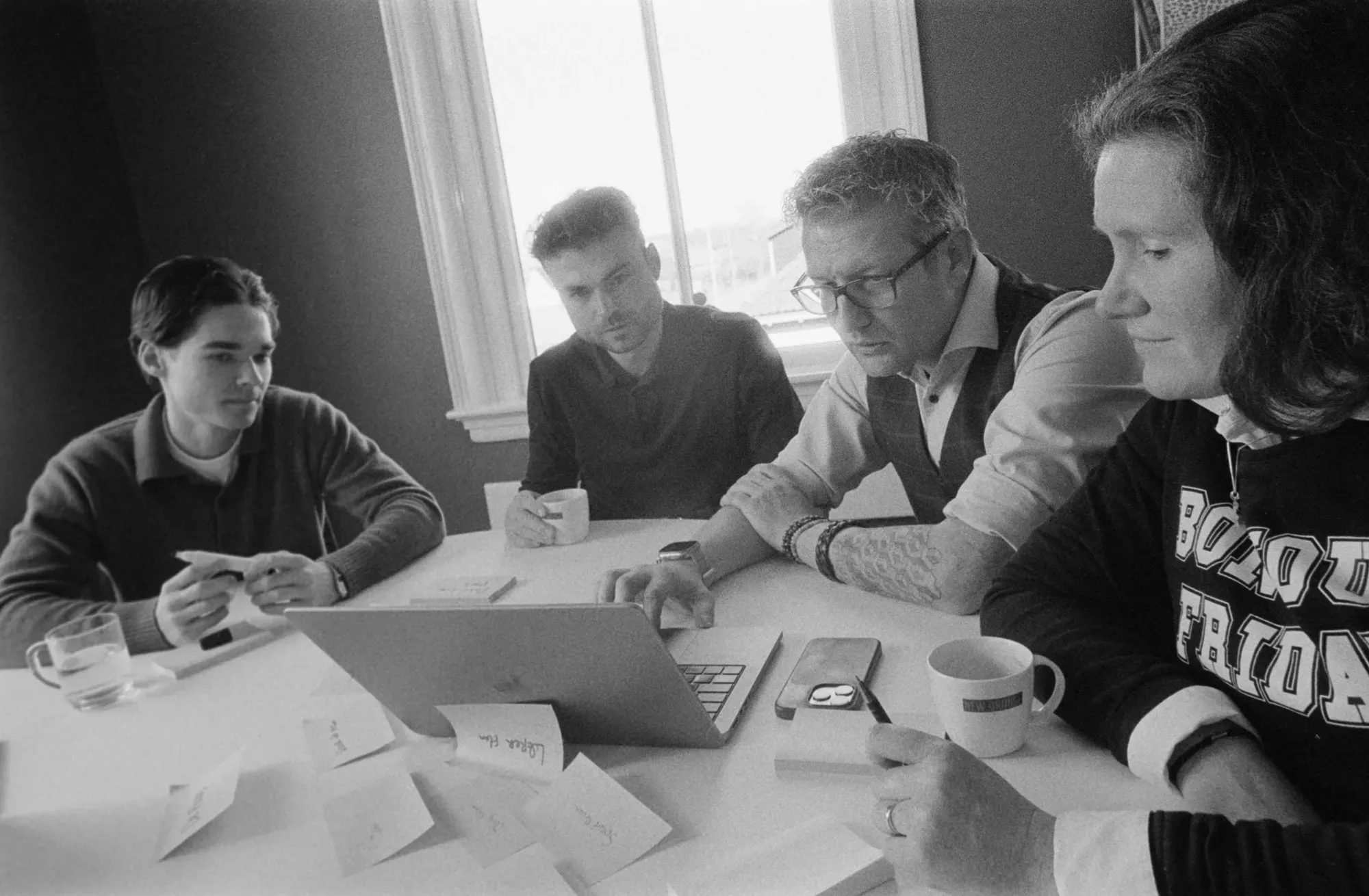 Four colleagues behind laptop