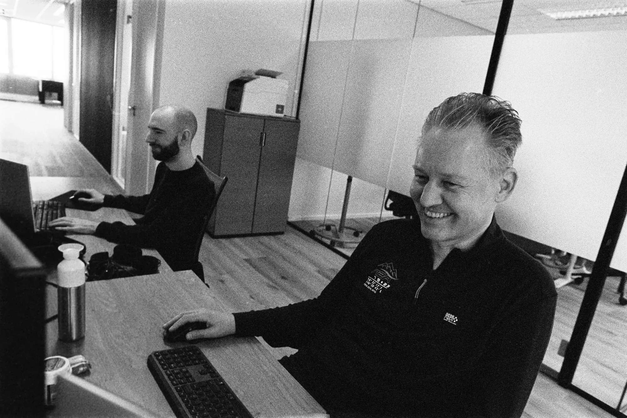 Colleagues smiling at desk