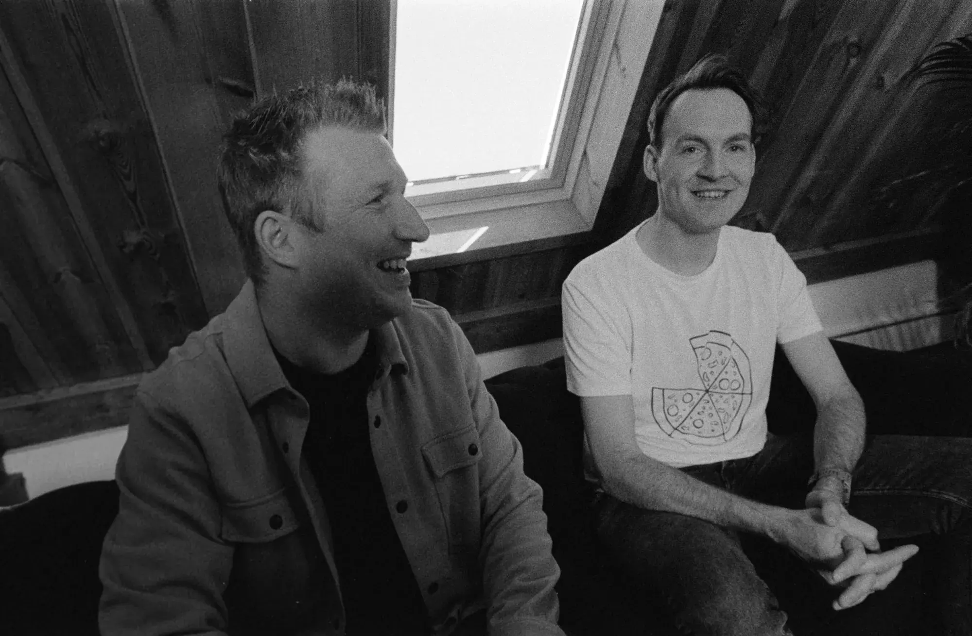 Dirk Pennings and Tom Hofman laughing on a couch