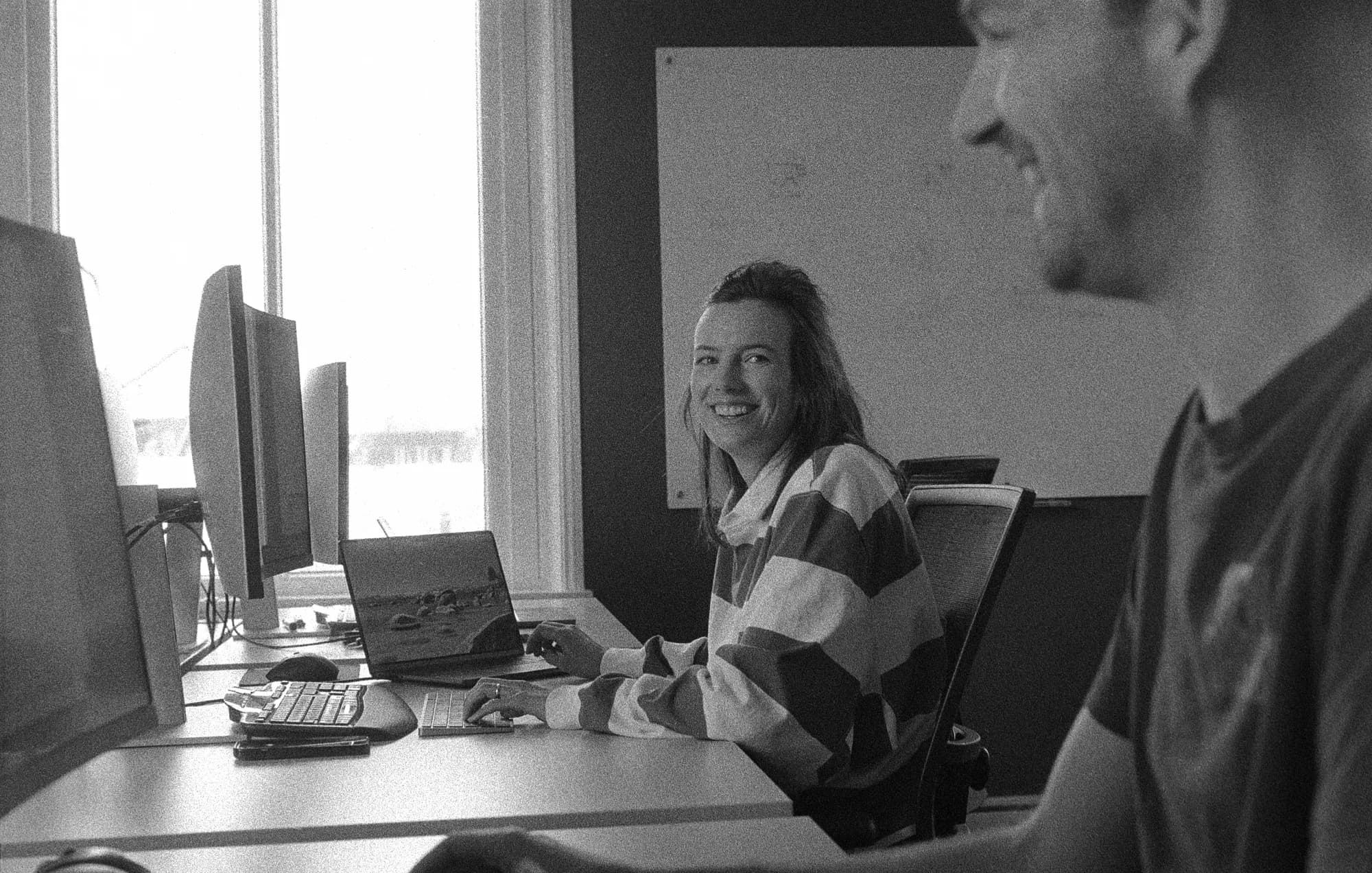 Two colleagues looking at eachother smiling